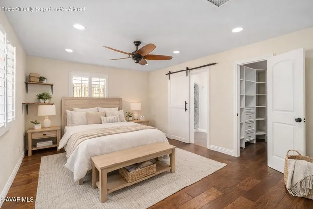closeup of a bathroom with a granite countertop sink and a toilet