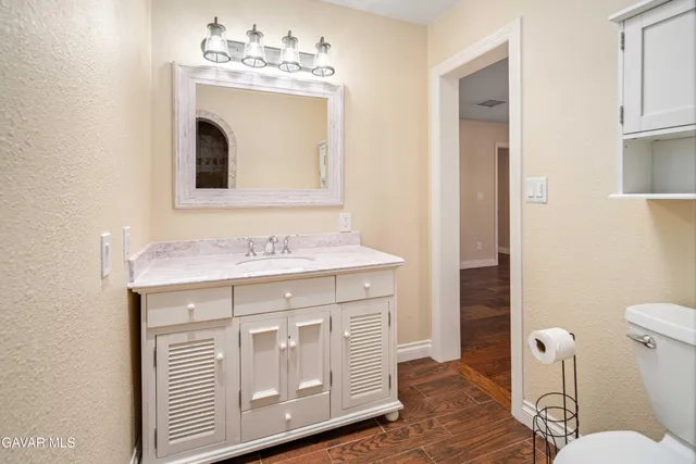 a view of a big room with wooden cabinet and windows
