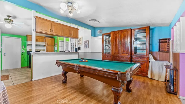 a room with pool table and windows