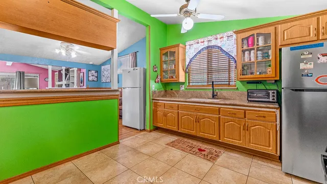 a kitchen with stainless steel appliances granite countertop a refrigerator and a stove