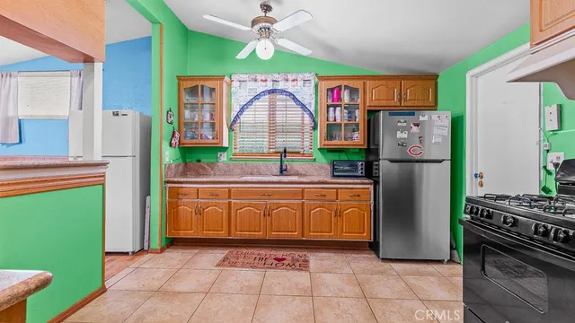 a kitchen with stainless steel appliances granite countertop a refrigerator and a stove