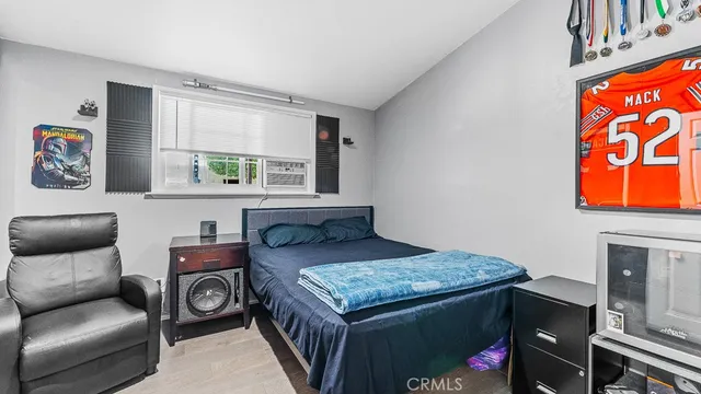 a bed sitting in a bedroom next to a window