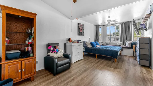 a bedroom with furniture and a wooden floor
