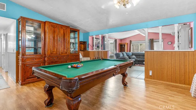 a room with pool table and windows