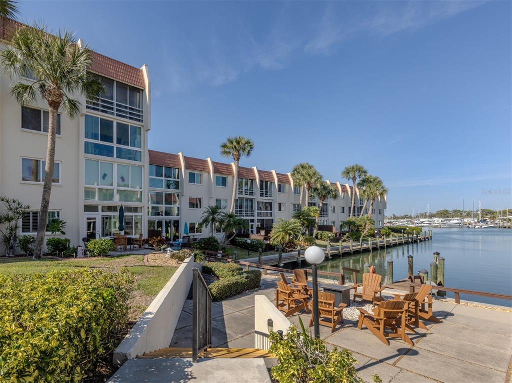 a view of swimming pool with outdoor seating and buildings in the background