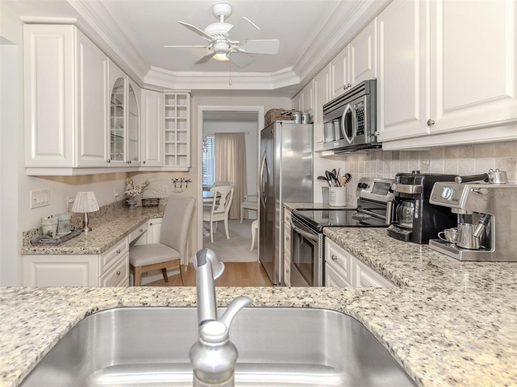 230 Santa Maria Street, Unit 330 Venice, FL 34285 - Photo 14 of 59 a kitchen with stainless steel appliances granite countertop a sink stove and cabinets