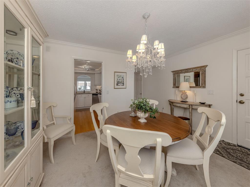 230 Santa Maria Street, Unit 330 Venice, FL 34285 - Photo 18 of 59 a view of a dining room with furniture and chandelier