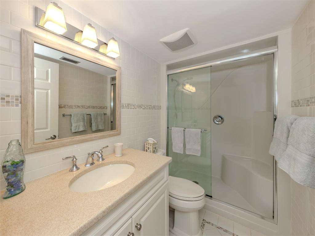 230 Santa Maria Street, Unit 330 Venice, FL 34285 - Photo 23 of 59 a bathroom with a granite countertop sink toilet and shower
