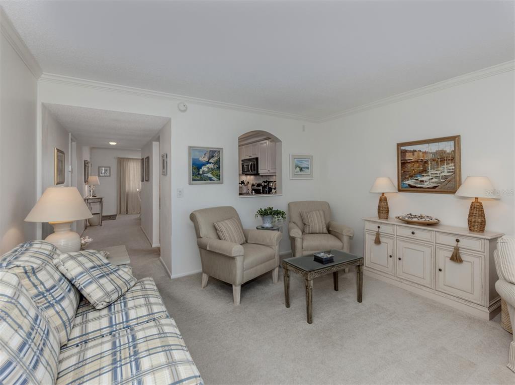 230 Santa Maria Street, Unit 330 Venice, FL 34285 - Photo 28 of 59 a living room with furniture and a lamp