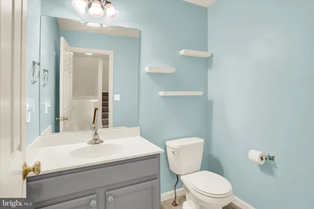 a kitchen with stainless steel appliances granite countertop a stove top oven a sink and a refrigerator