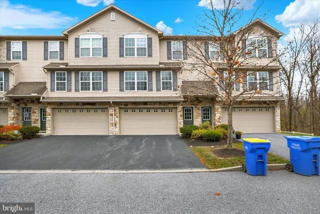 a front view of a house with outdoor space and a garden