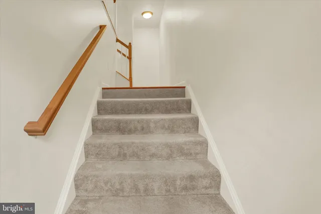 a view of staircase with white walls