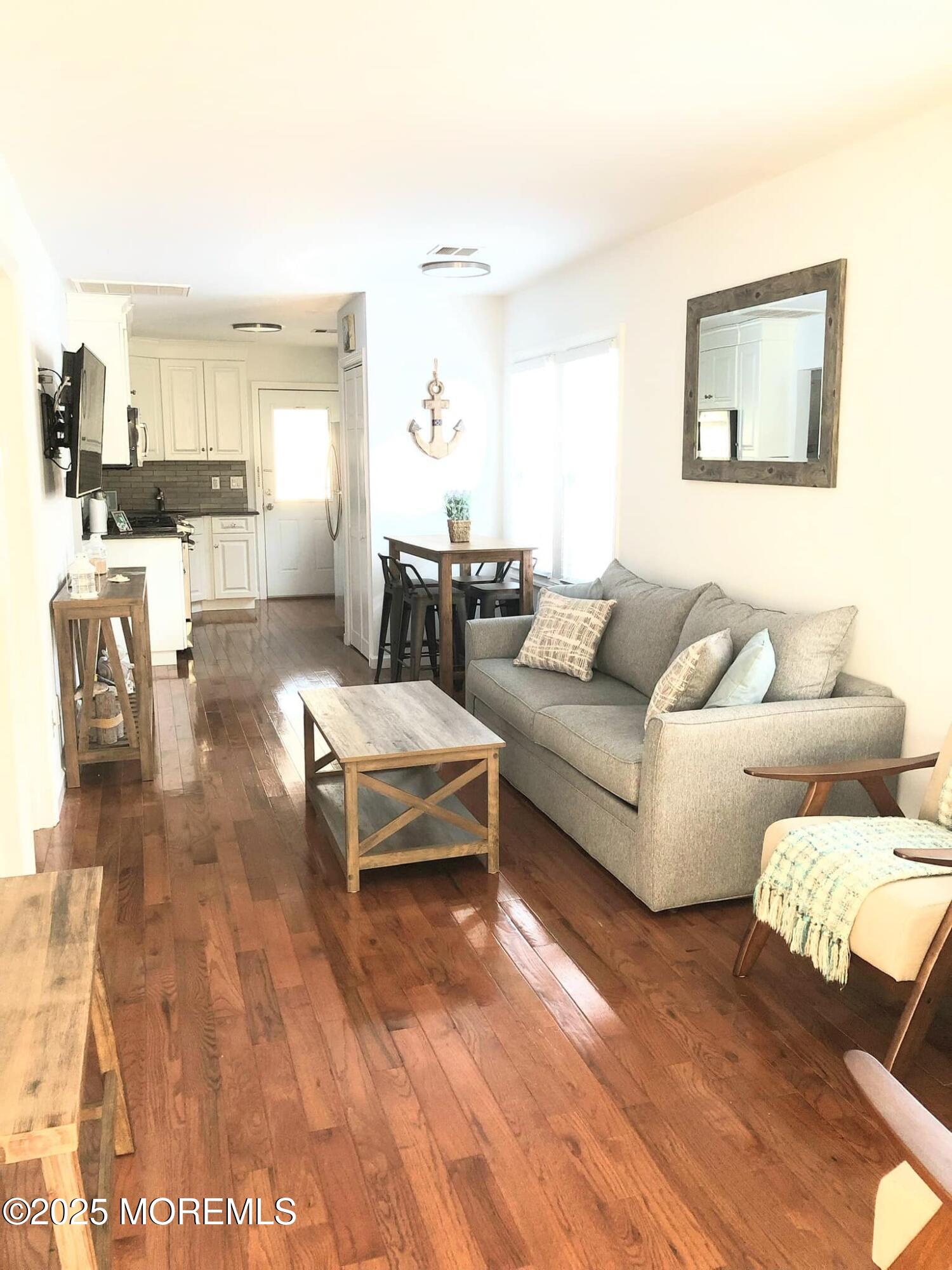 222 Franklin Avenue Seaside Heights, NJ 08751 - Photo 2 of 14 a living room with furniture and a large window