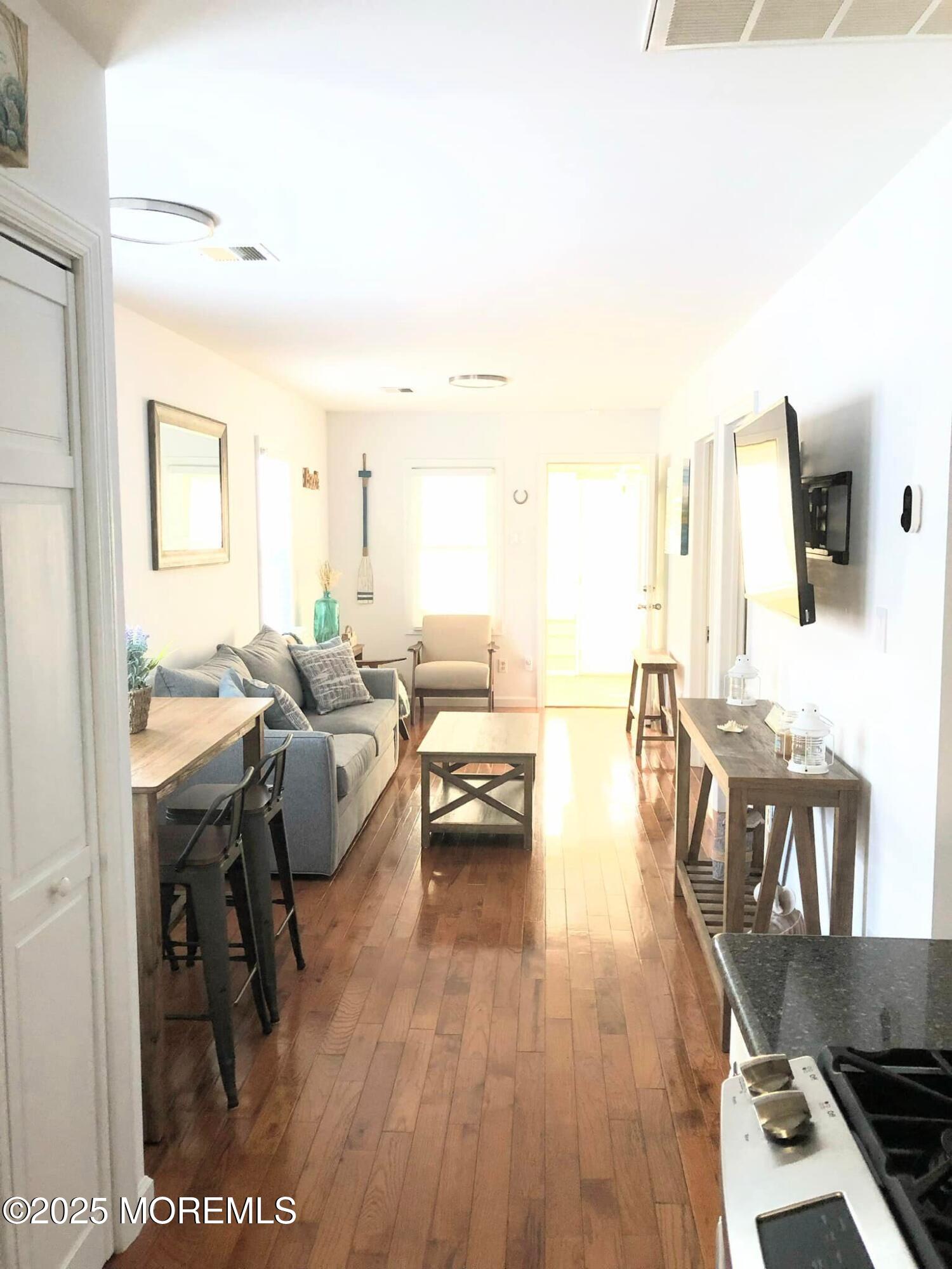 222 Franklin Avenue Seaside Heights, NJ 08751 - Photo 3 of 14 a living room with furniture a wooden floor and next to a window