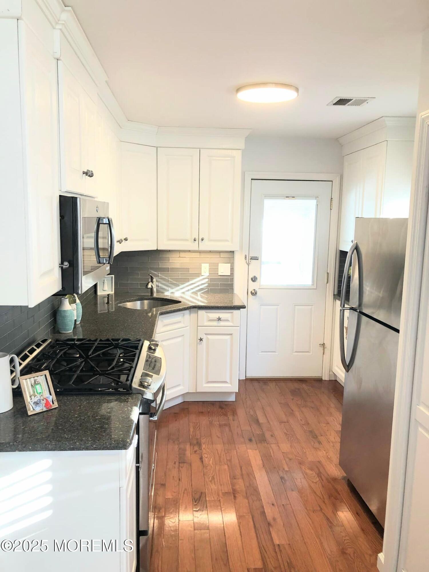 222 Franklin Avenue Seaside Heights, NJ 08751 - Photo 5 of 14 a kitchen with a refrigerator and a stove top oven