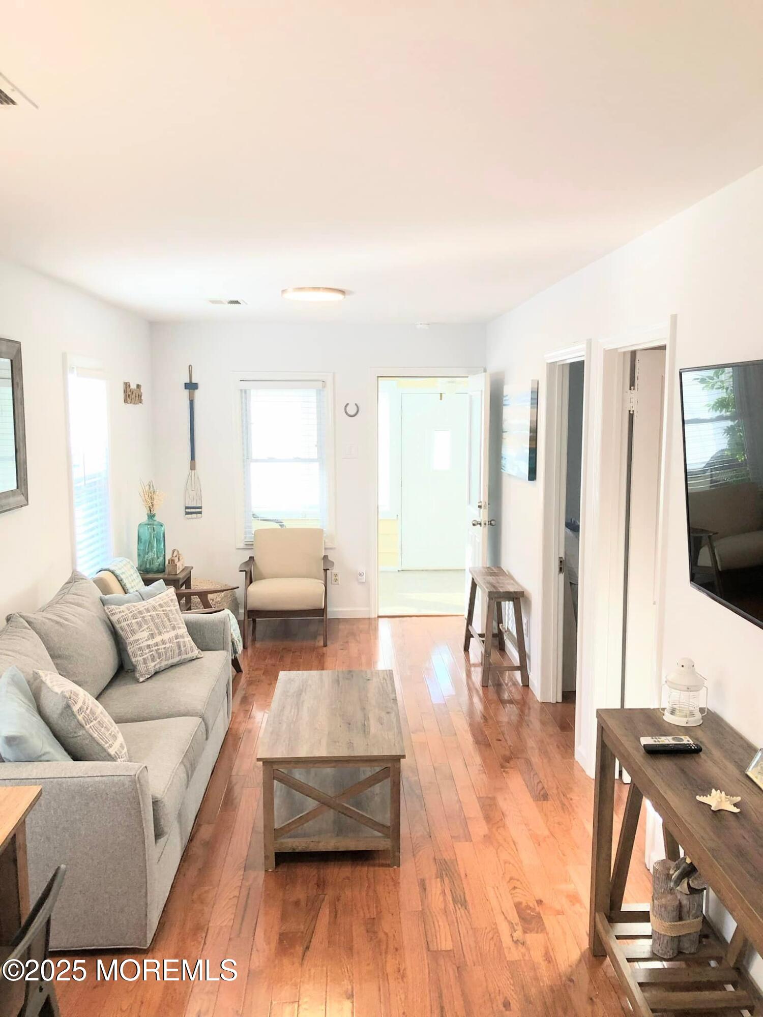 222 Franklin Avenue Seaside Heights, NJ 08751 - Photo 7 of 14 a living room with furniture and a flat screen tv
