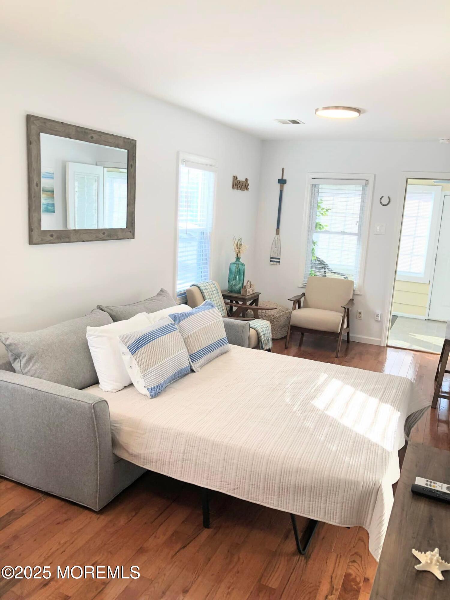 222 Franklin Avenue Seaside Heights, NJ 08751 - Photo 8 of 14 a bedroom with a bed and wooden floor