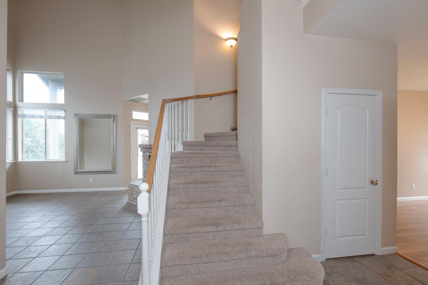 1361 Birch Avenue Clovis, CA 93611 - Photo 13 of 43 a view of a hallway with wooden floor and staircase