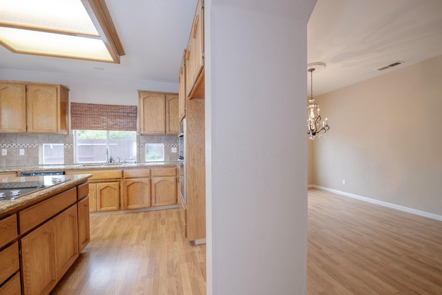 1361 Birch Avenue Clovis, CA 93611 - Photo 22 of 43 a kitchen with granite countertop a sink and cabinets