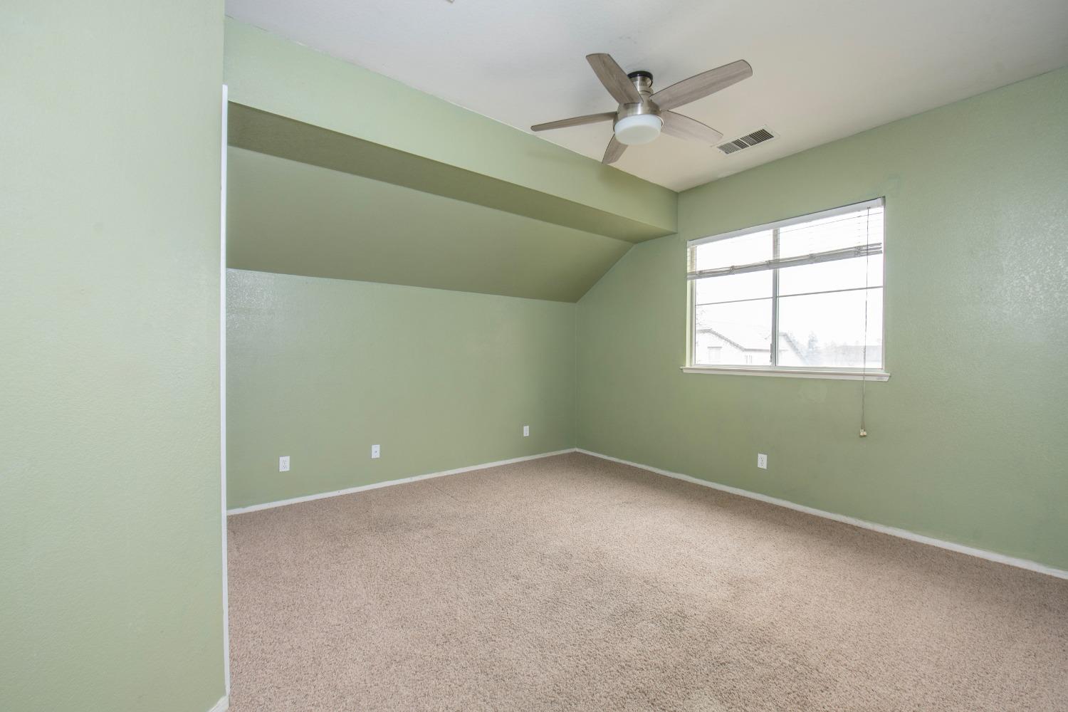 1361 Birch Avenue Clovis, CA 93611 - Photo 30 of 43 an empty room with a ceiling fan and window