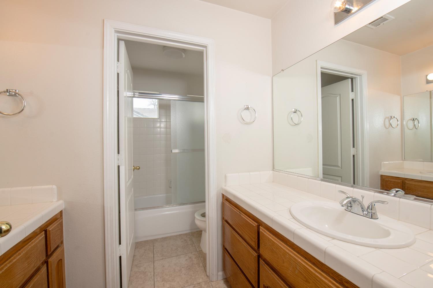 1361 Birch Avenue Clovis, CA 93611 - Photo 32 of 43 a bathroom with a sink a toilet and shower