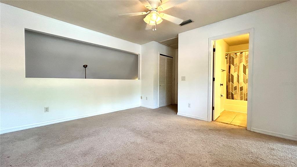 5855 Southwest 8th Place Gainesville, FL 32607 - Photo 18 of 19 an empty room with a fan and a window