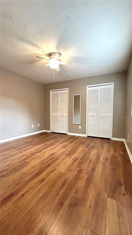 5855 Southwest 8th Place Gainesville, FL 32607 - Photo 4 of 19 an empty room with wooden floor and windows