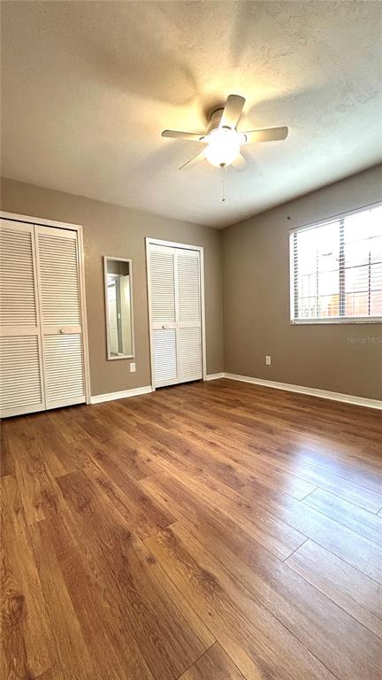 5855 Southwest 8th Place Gainesville, FL 32607 - Photo 5 of 19 an empty room with wooden floor and windows