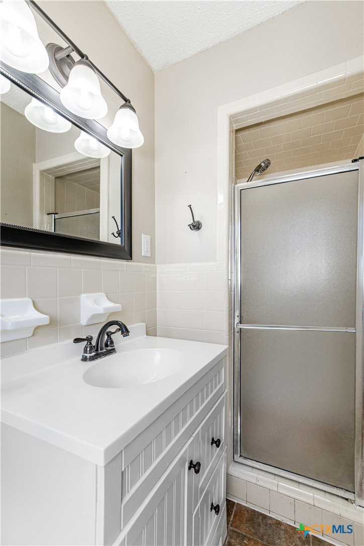 121 Bonham Street Port Lavaca, TX 77979 - Photo 11 of 26 a bathroom with a sink and a mirror