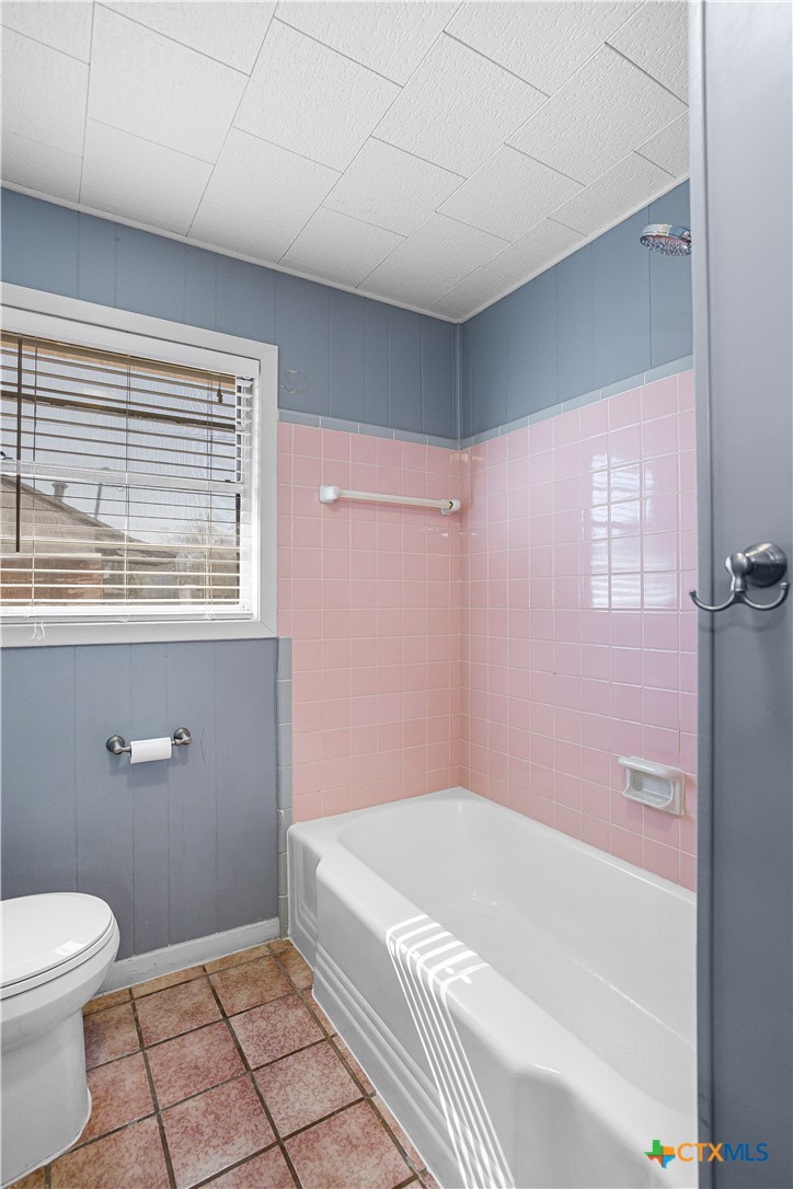 121 Bonham Street Port Lavaca, TX 77979 - Photo 13 of 26 a bathroom with a granite countertop bathtub shower and toilet