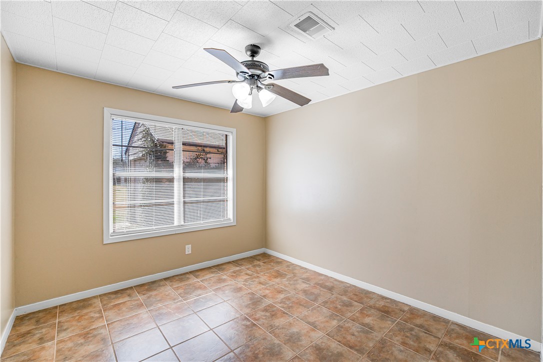 121 Bonham Street Port Lavaca, TX 77979 - Photo 14 of 26 an empty room with windows and fan
