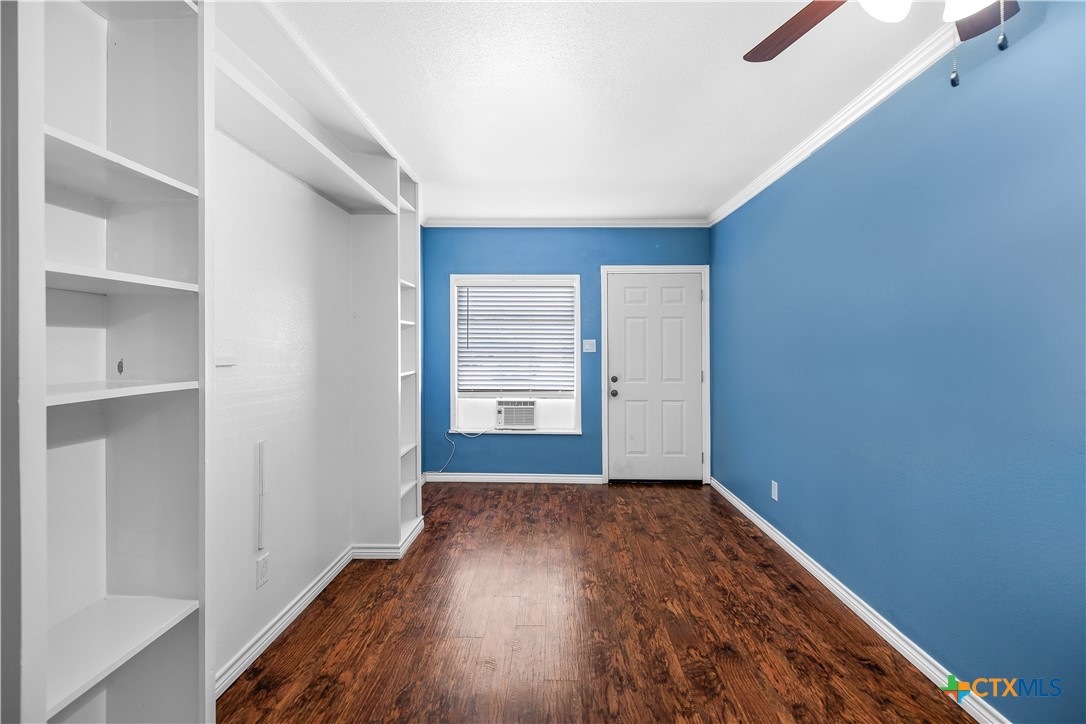 121 Bonham Street Port Lavaca, TX 77979 - Photo 16 of 26 an empty room with wooden floor and windows