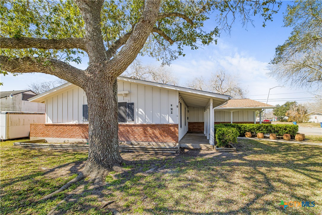 121 Bonham Street Port Lavaca, TX 77979 - Photo 2 of 26 a view of a house with a tree in front of it