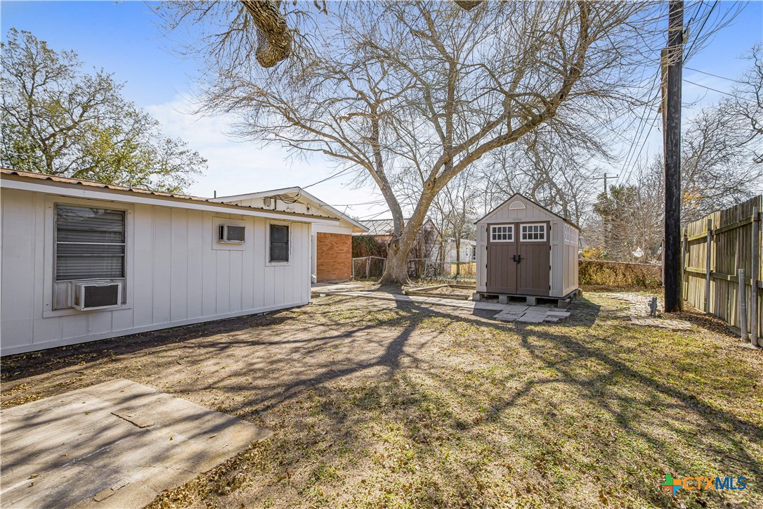 121 Bonham Street Port Lavaca, TX 77979 - Photo 22 of 26 a view of house with backyard and tree