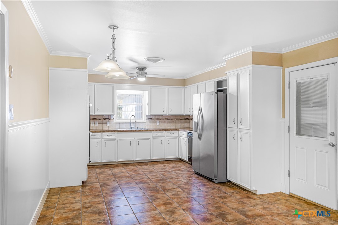 121 Bonham Street Port Lavaca, TX 77979 - Photo 6 of 26 a kitchen with a refrigerator and a sink