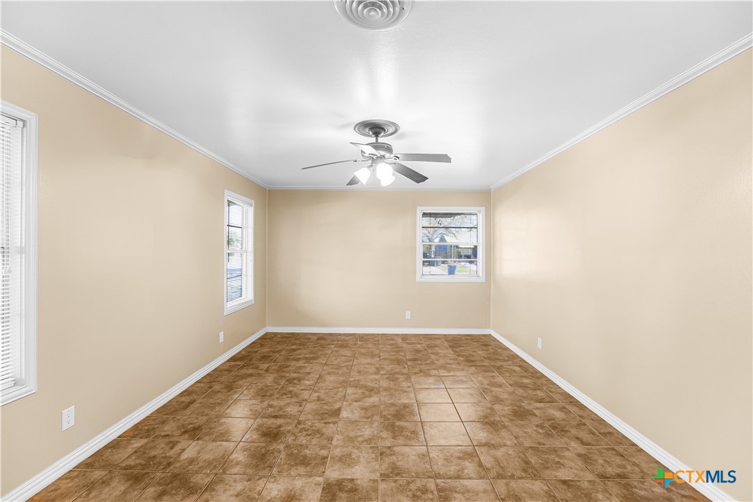121 Bonham Street Port Lavaca, TX 77979 - Photo 8 of 26 a view of a room with a window and a ceiling fan