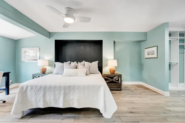 a bedroom with a bed and a chandelier