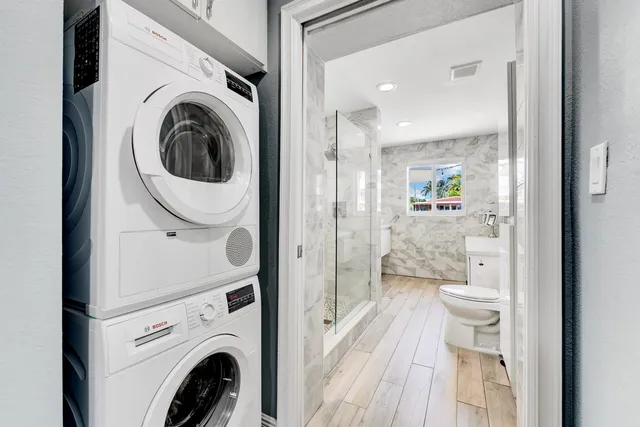 a view of a hallway with washer and dryer