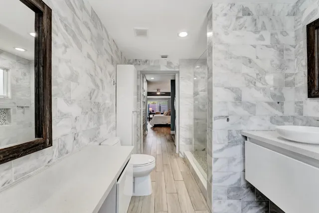 a bathroom with a sink toilet and shower