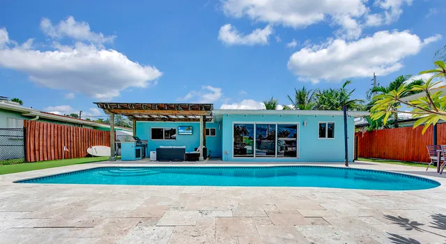 a view of a big house with a big yard and large trees