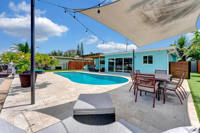 a view of a patio with a table and chairs