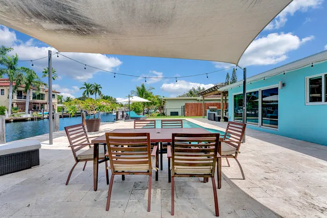 a view of an outside dining space with furniture