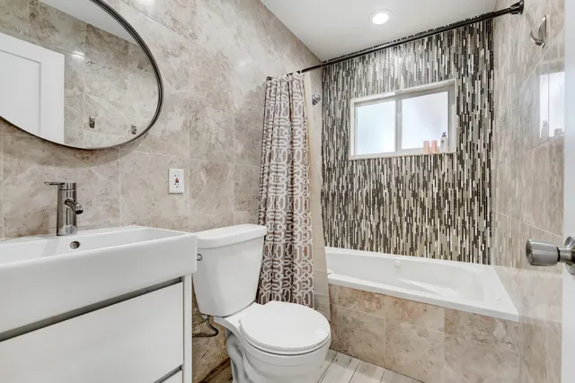 a bathroom with a sink a toilet and a mirror