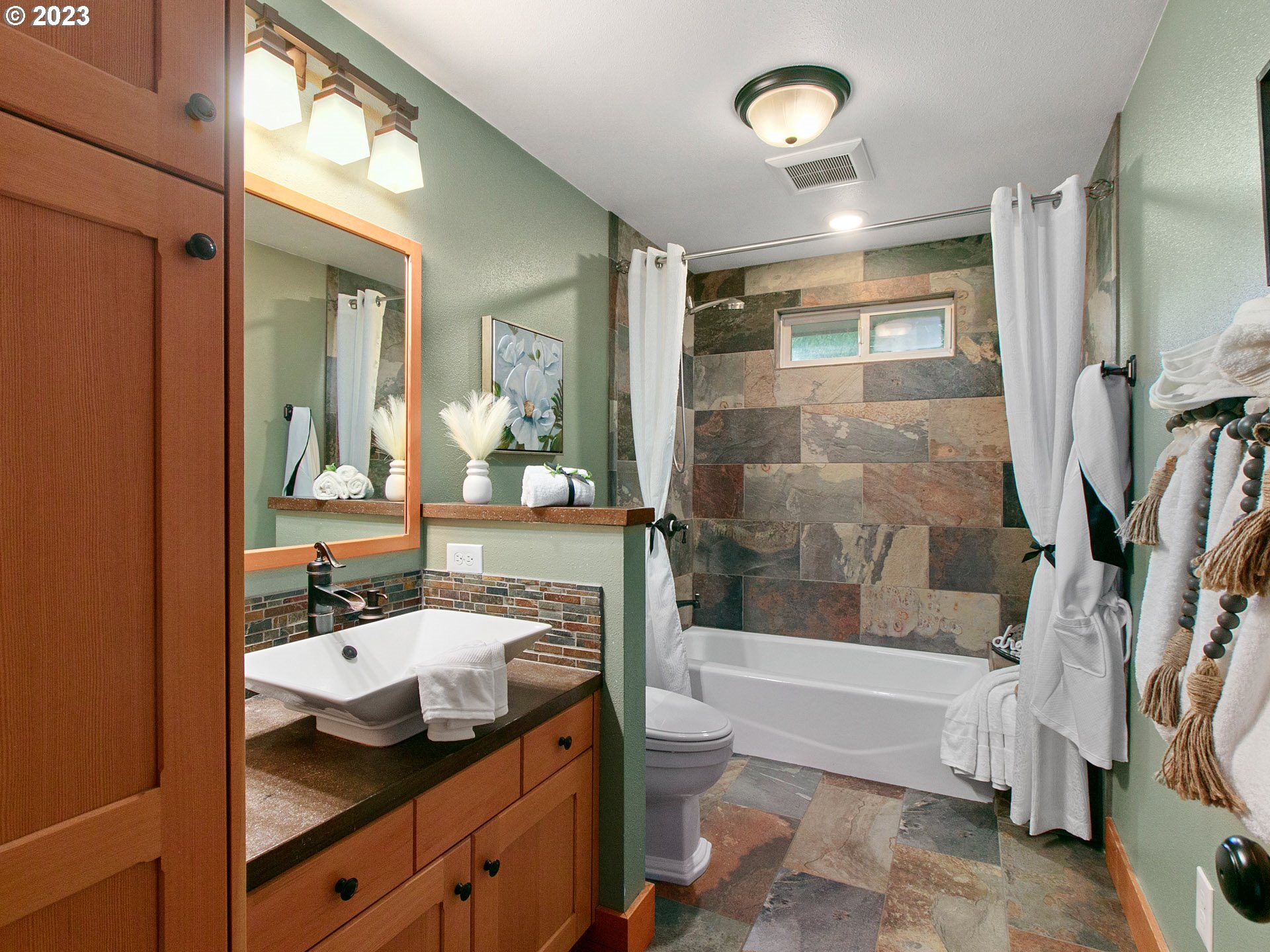 21237 South Ridgeway Lane Oregon City, OR 97045 - Photo 17 of 32 a bathroom with a granite countertop sink a mirror and a bathtub