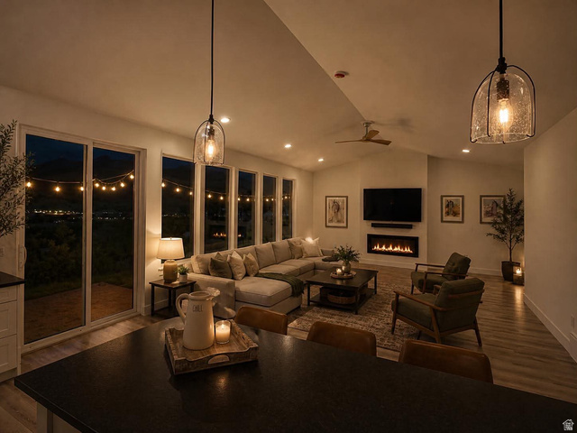 905 Settlement Canyon Road Tooele, UT 84074 - Photo 2 of 12 Spacious living area featuring a vaulted ceiling with recessed lighting and a ceiling fan, wood-finish flooring, and a wall-mounted linear fireplace