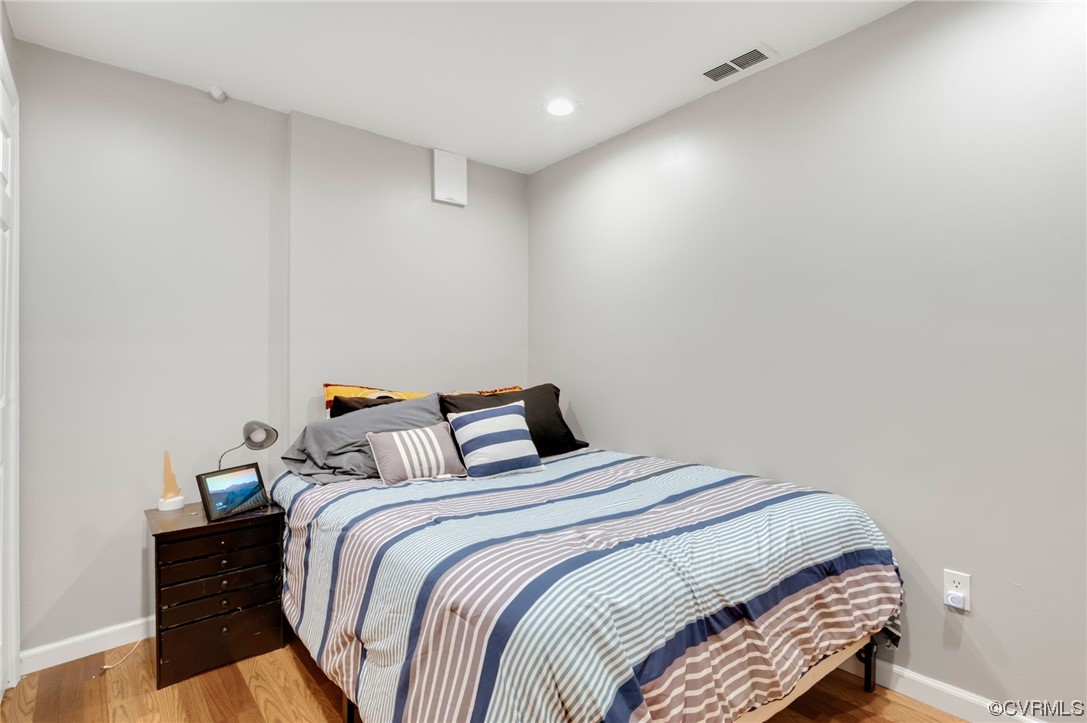 353 Nottoway Lane King William, VA 23086 - Photo 32 of 33 a bedroom with a bed and a lamp with wooden floor