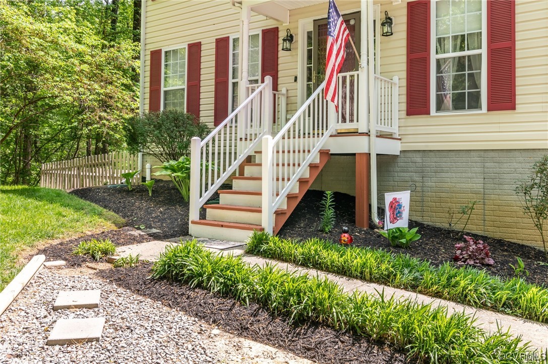 353 Nottoway Lane King William, VA 23086 - Photo 4 of 33 a view of a house with a yard and flower plants