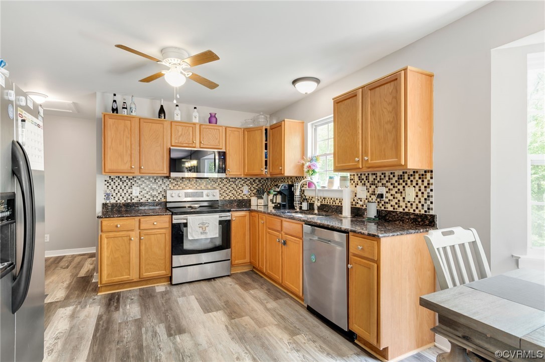 353 Nottoway Lane King William, VA 23086 - Photo 7 of 33 a kitchen with granite countertop white cabinets a sink a window and stainless steel appliances