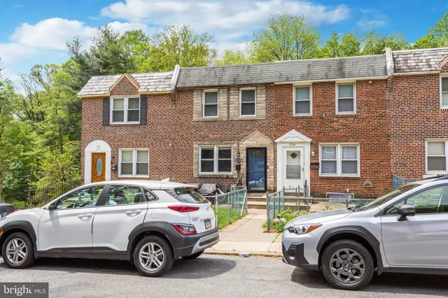 a car parked in front of a brick house