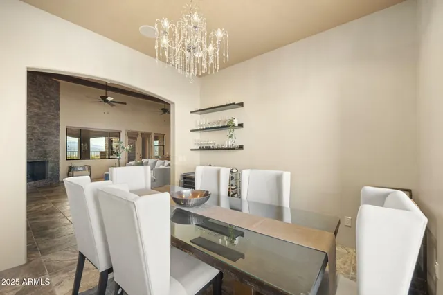 a view of a dining room with furniture and chandelier